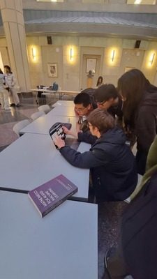 Feodor—triple gold medalist in physics, astronomy, and mathematics—explaining a problem to other contestants; *Mathematics for AI and Machine Learning* (my book)